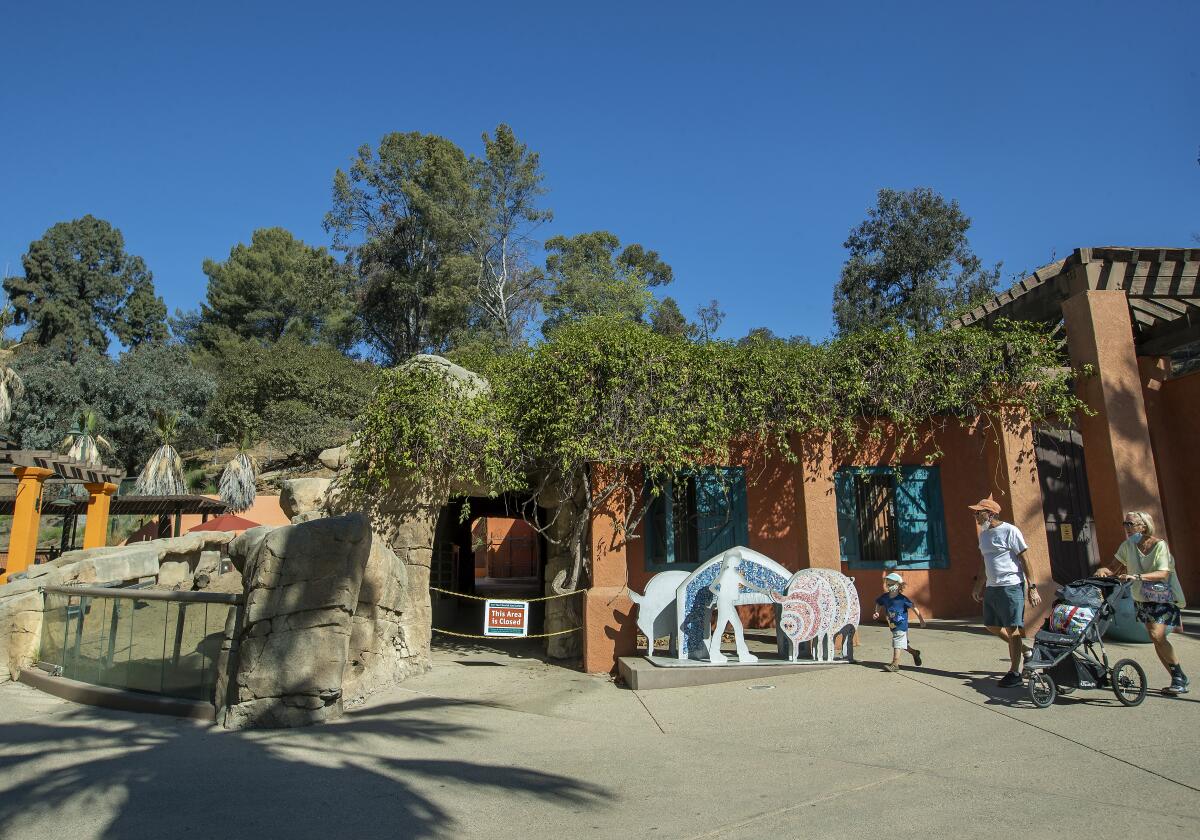 A family walks through the L.A. Zoo