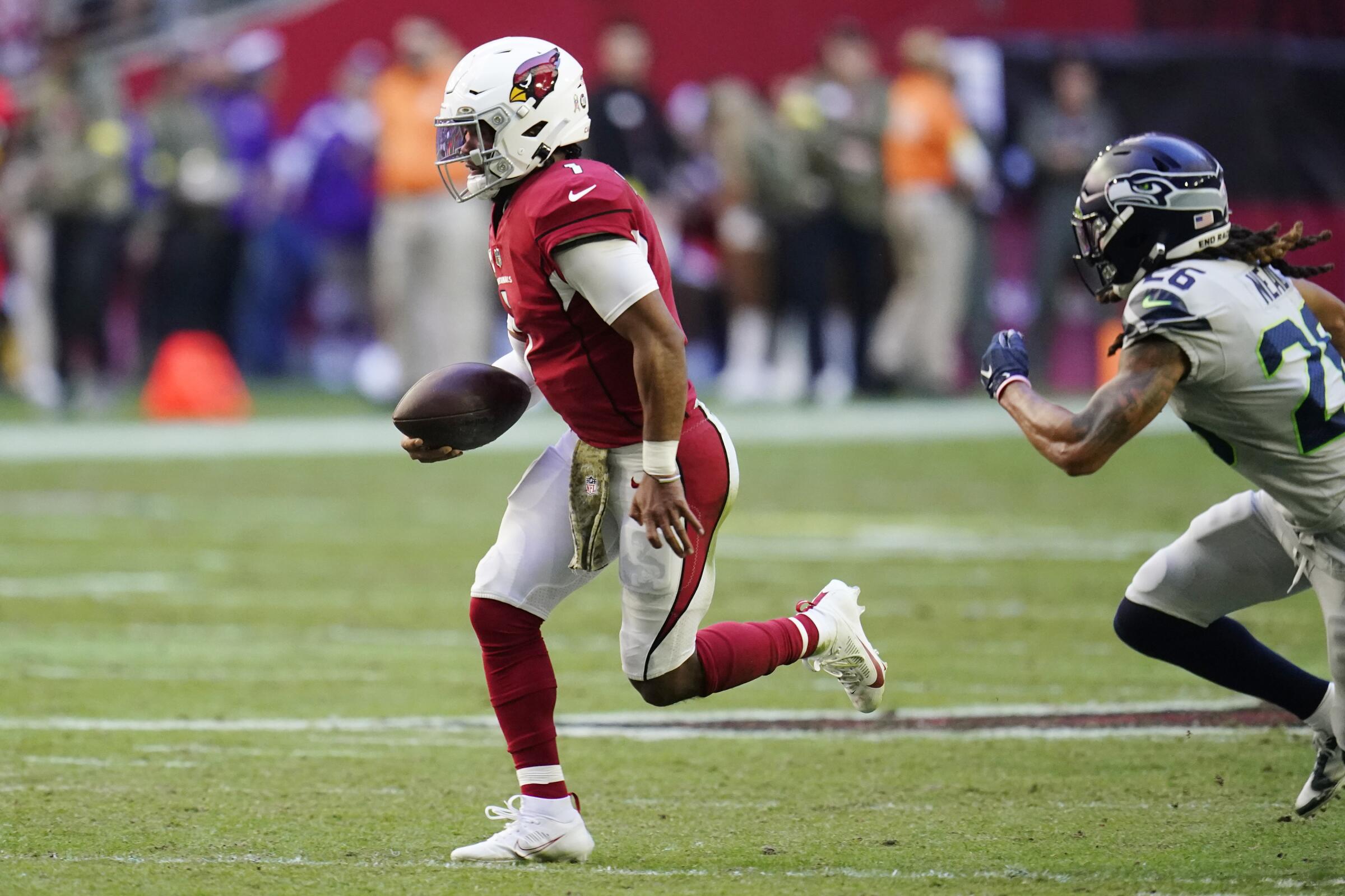 Cardinals quarterback Kyler Murray runs with the ball against Seahawks safety Ryan Neal on Nov. 6, 2022.