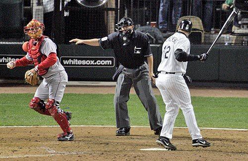 Umpire Doug Eddings puts his hand out, signaling that A.J. Pierzynski swung at the pitch from Kelvim Escobar.