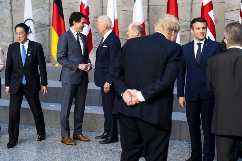 Canadian Prime Minister Justin Trudeau and President Joe Biden talk prior to posing for a G7 leaders' group photo.