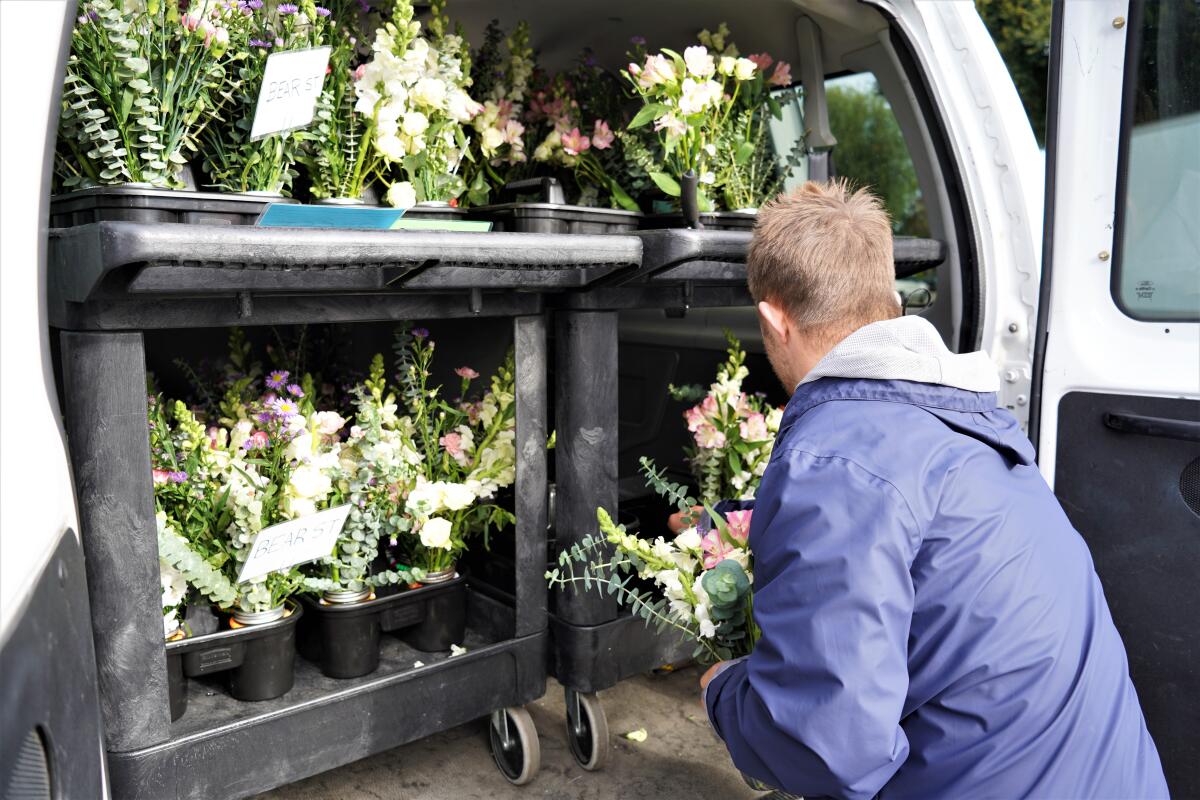 Zeke Eampietro, 21, rearranges bouquets Tuesday in a van used by Newport-Mesa Unified's STEP program.