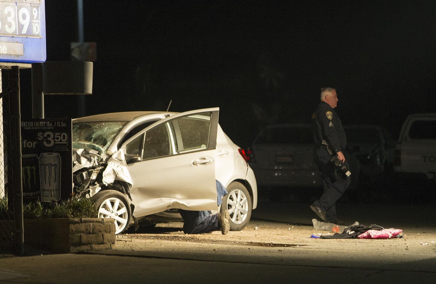 Ontario police investigate the scene of a two-car crash that left five dead Thursday.