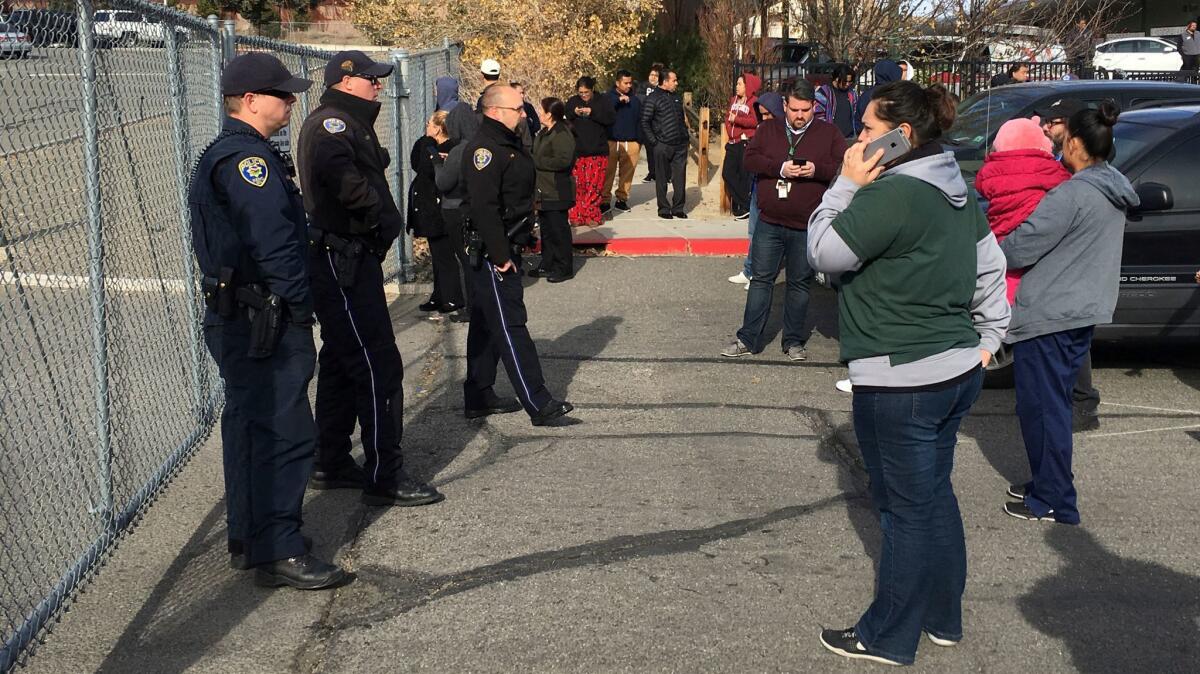 Parents wait outside Hug High School in Reno after a shooting forced a campus lockdown.