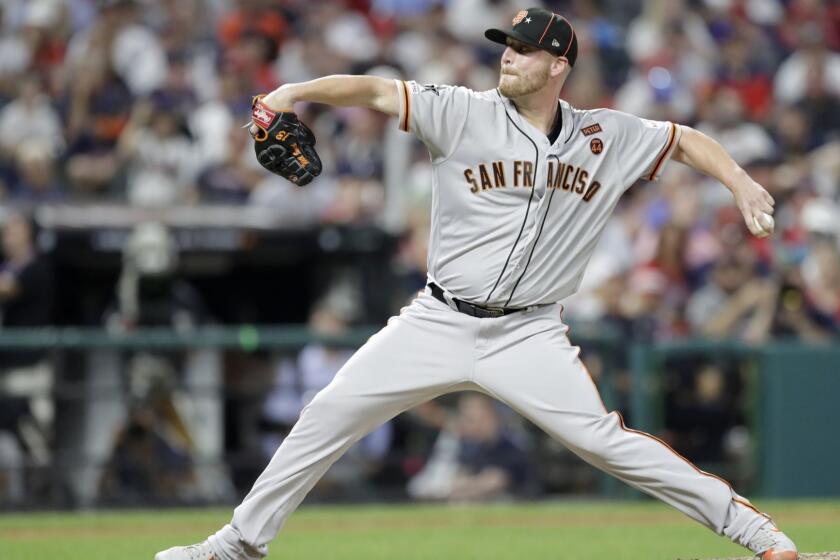 National League pitcher Will Smith, of the San Francisco Giants, throws during the seventh inning of the MLB baseball All-Star Game American League, Tuesday, July 9, 2019, in Cleveland. (AP Photo/Tony Dejak)