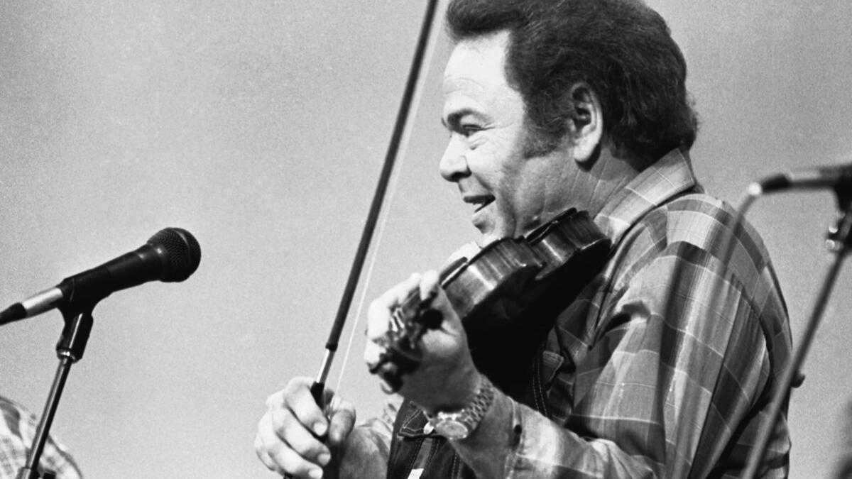 Roy Clark, in 1983 during a taping of the syndicated TV show "Hee Haw," died Thursday.