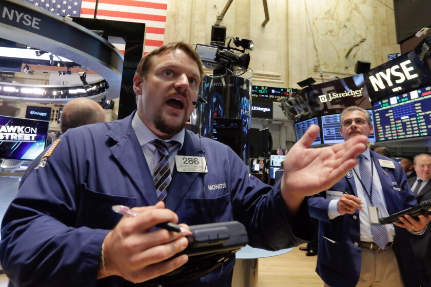 Trader Michael Milano works on the floor of the New York Stock Exchange on Sept. 1.