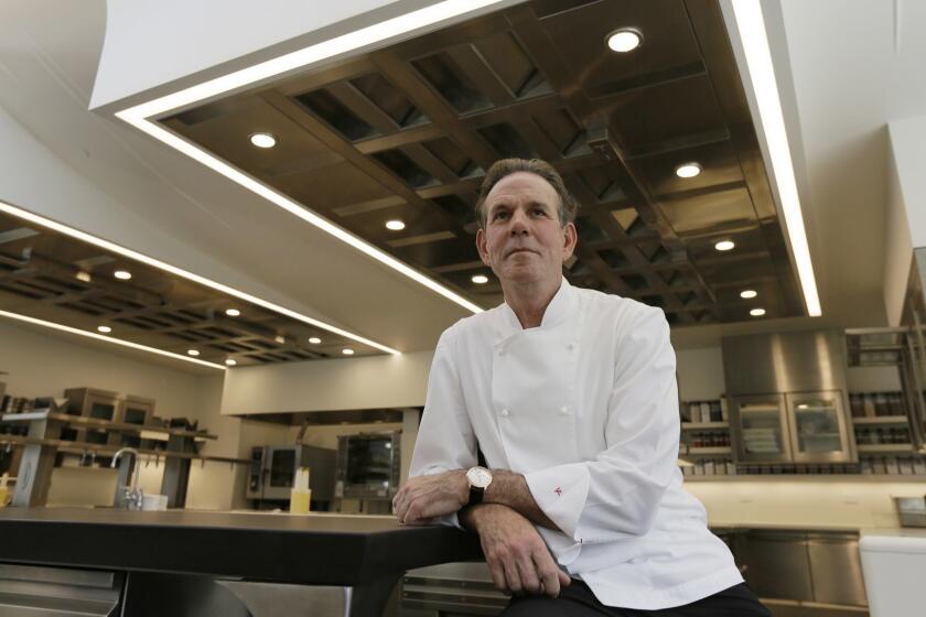 FILE - This March 9, 2017, file photo, shows celebrated chef Thomas Keller in the kitchen of his French Laundry restaurant in Yountville, Calif. A former employee of celebrated chef Thomas Keller is suing him and his three-star Michelin restaurants, Per Se in New York and the French Laundry in California, for discrimination, saying she was denied a job transfer and ultimately let go because she was pregnant. Vanessa Scott-Allen is seeking $5 million in damages for allegations that include sex discrimination and violation of pregnancy disability leave and says she hopes her trial, which starts Monday, June 3, 2019, will draw attention to a "culture of misogyny in fine dining," said her attorney, Carla Minnard. (AP Photo/Eric Risberg, File)