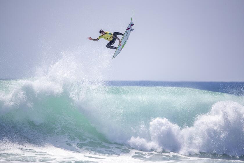 Gabriel Medina soars high on a big wave as he beats fFilipe Toledo to win the World Surf League Championship Title