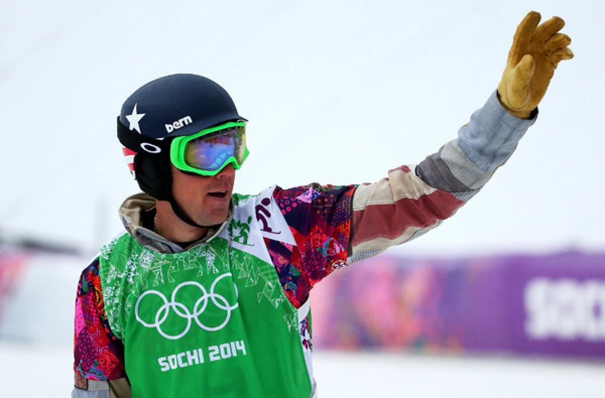 Alex Deibold of the United States celebrates after advancing from a heat men's snowboard cross on Tuesday at Rosa Khutor Extreme Park.