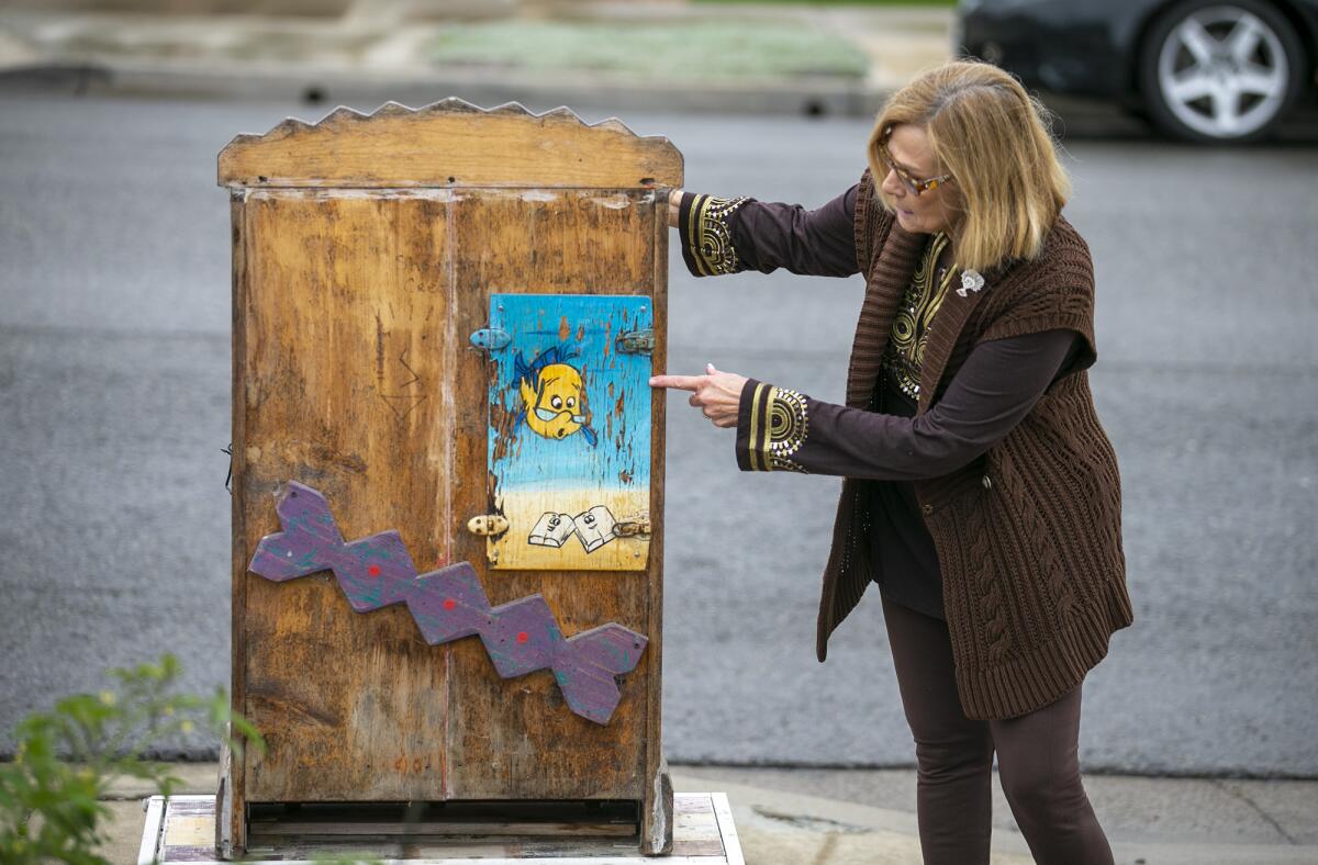 The door of the first free book box, installed at the home of the Ashendorfs in Costa Mesa, is affixed to a newer cabinet.