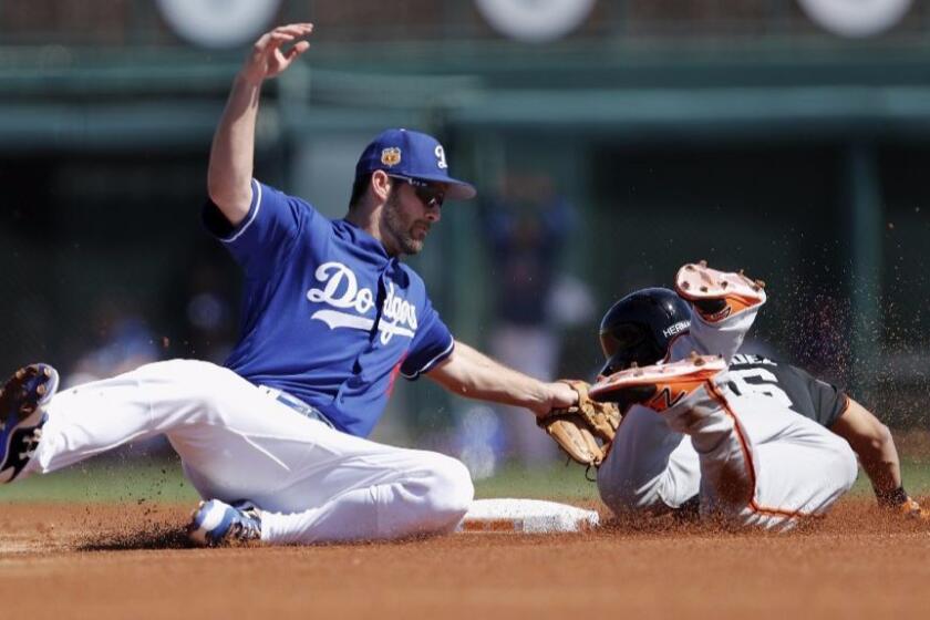 Dodgers second baseman Charlie Culberson tags out Giants outfielder Gorkys Hernandez on a steal attempt during a spring training game on March 7.