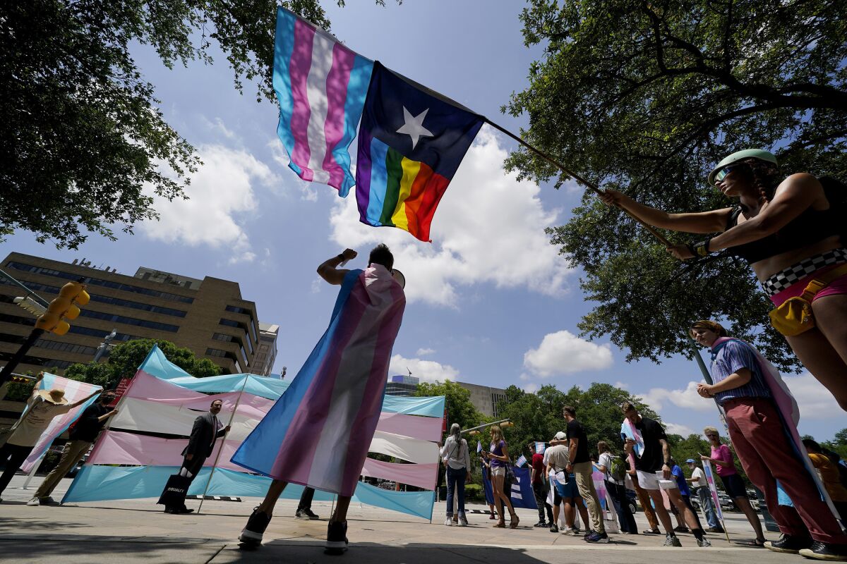Demonstrators gather on the steps to the State Capitol to speak against transgender-related legislation in Austin, Texas. 