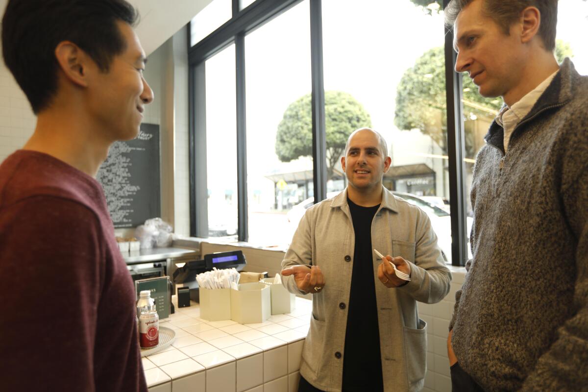 Nicolas Jammet, center, co-founder of Sweetgreen, speaks to Joshua Hu, left, and Kevin Quandt at the company's location in Santa Monica.