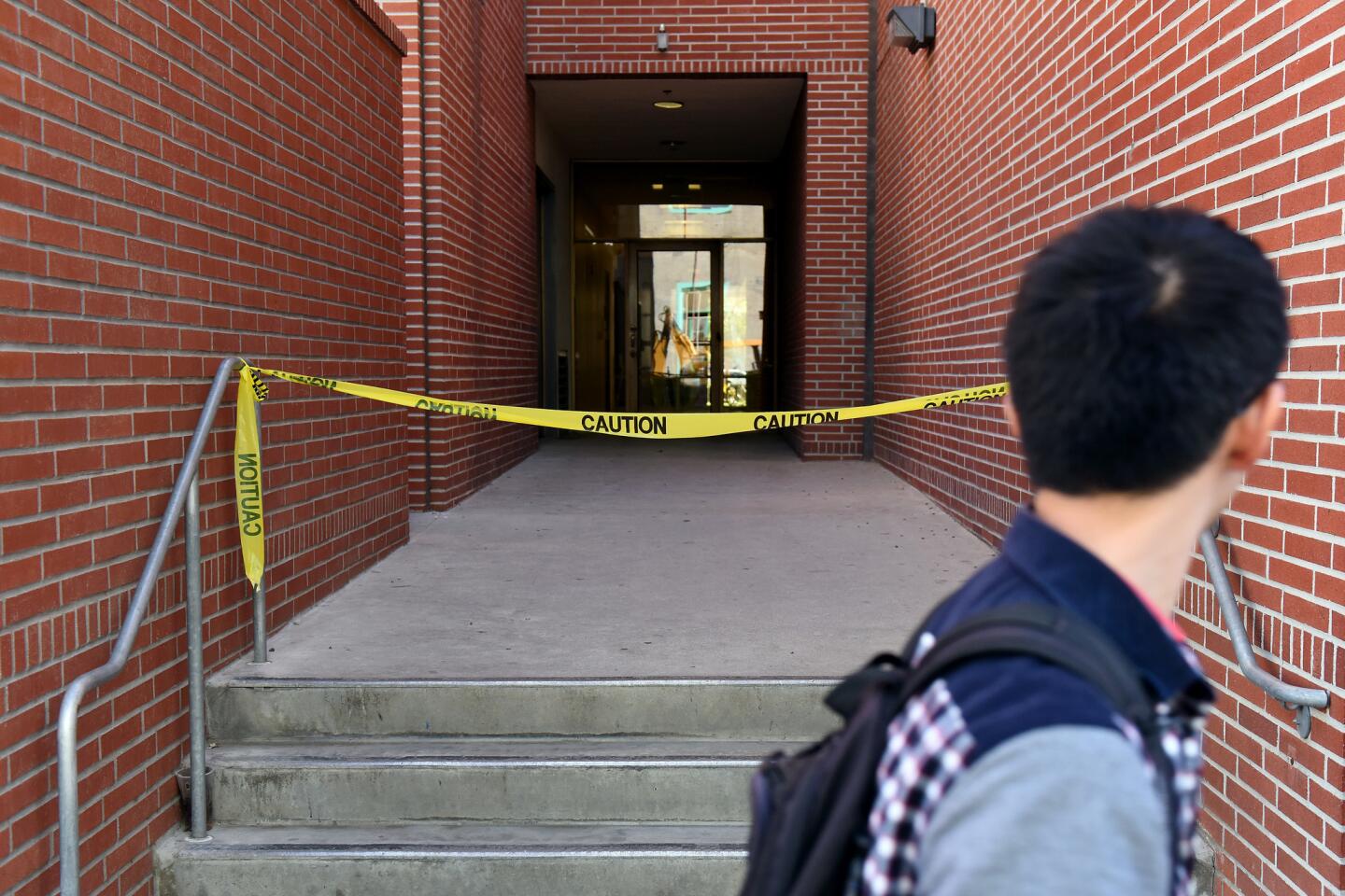 A student walks by the Seeley G. Mudd building on the USC campus where USC psychology professor Bosco Tjan was stabbed to death.