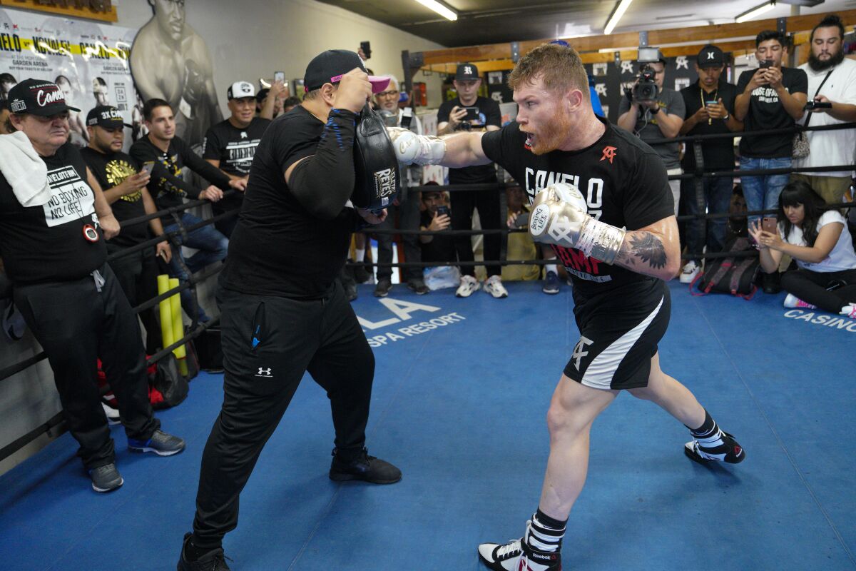 Canelo Álvarez works out with his trainer at the House of Boxing in San Diego on Wednesday, October 23, 2019.