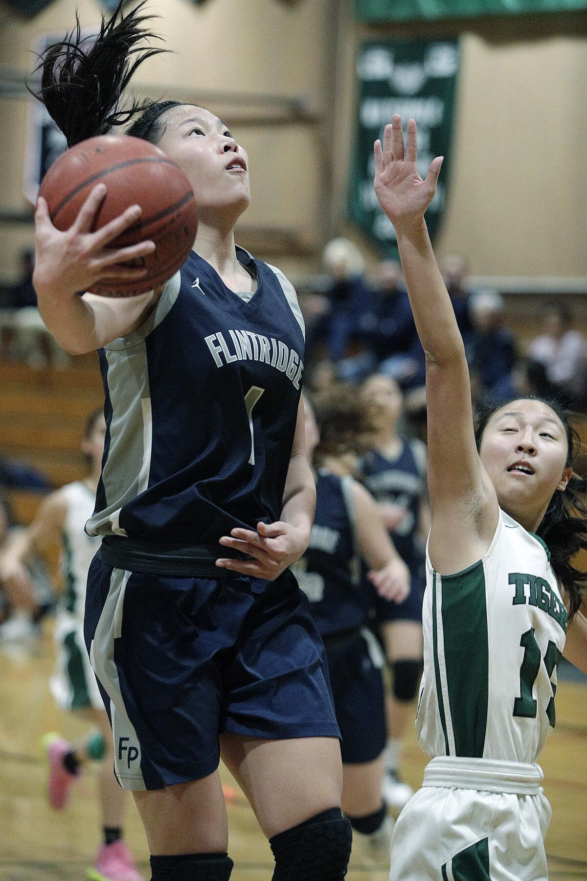 Flintridge Prep's Kaitlyn Chen drives and shoots against Westridge's Cassandra Kuo in a Prep League girls' basketball game at Westridge School in Pasadena on Thursday, January 16, 2020.