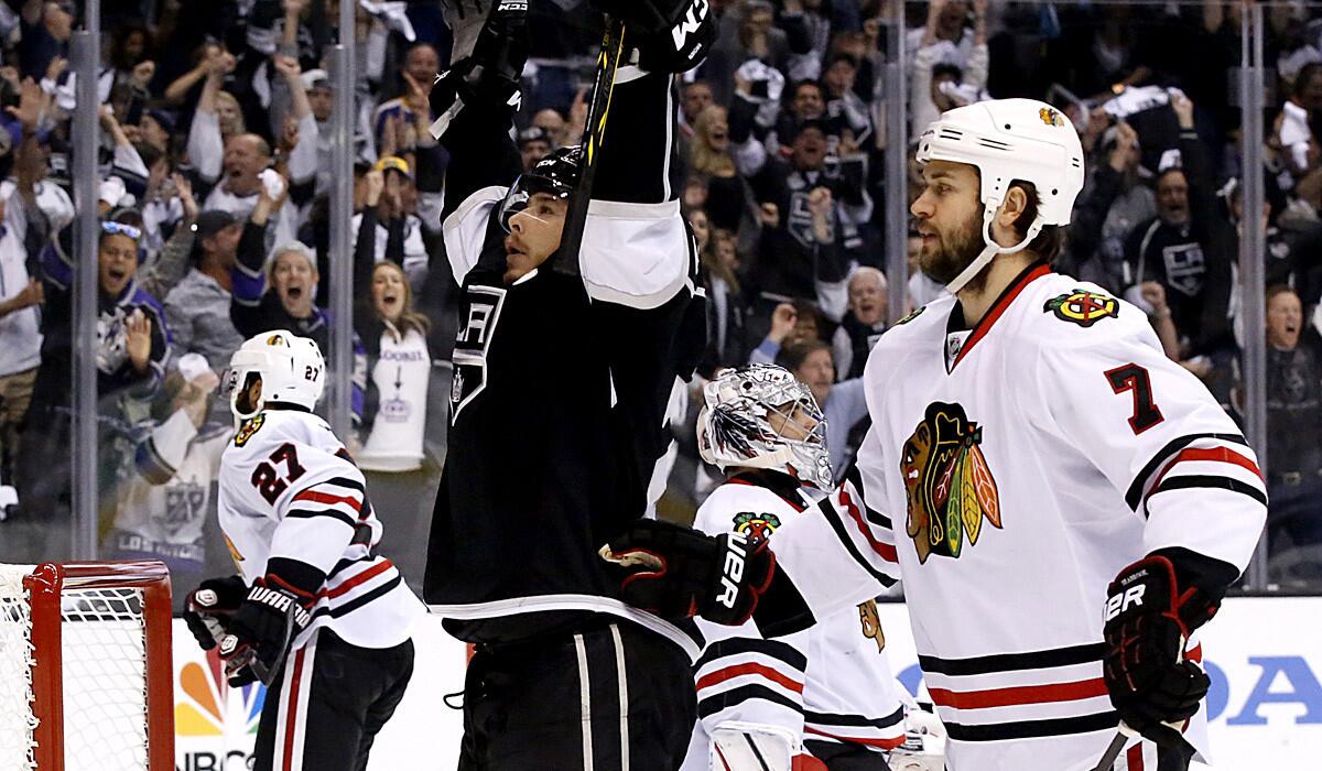 Kings captain Dustin Brown, left, celebrates in front of Chicago Blackhawks defenseman Brent Seabrook after scoring a first-period power-play goal in Game 4 of the Western Conference finals at Staples Center.