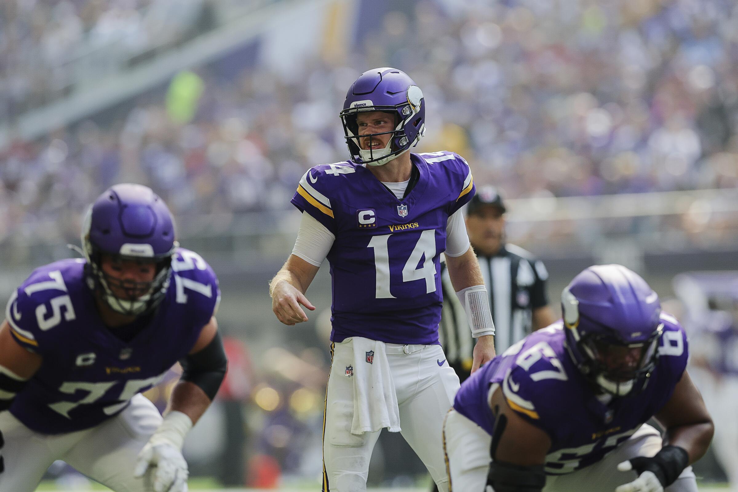 Minnesota Vikings quarterback Sam Darnold (14) calls out a play at the line of scrimmage.