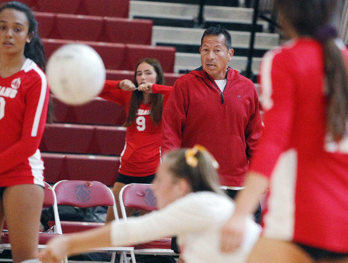 Burroughs' head coach Edwin Real watches his team climb out of a deficit to take over game one to win it against Arcadia in a Pacific League girls' volleyball match at Arcadia High School on Thursday, September 19, 2019. (Tim Berger / Staff Photographer)