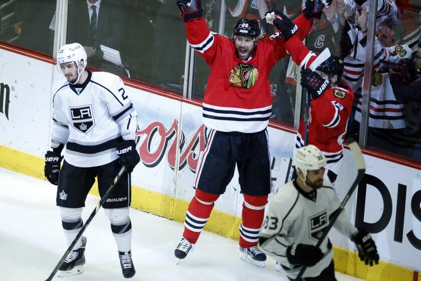 Chicago Blackhawks forward Michal Handzus, center, celebrates after scoring the winning goal in double overtime of the Kings' 5-4 loss in Game 5 of the Western Conference finals on Wednesday.