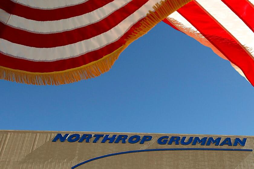 PALMDALE, CA JULY 17, 2014 -- The US flag flies near the U.S. Air Force's B-2 Spirit Stealth bomber "Spirit of Georgia" at the Northrop Grumman Corp. facility at U.S. Air Force Plant 42 in Palmdale on July 17, 2014 as Northrop Grumman hosts the 25th anniversary celebration of the first flight in the same location at the Palmdale Aircraft Integration Center of Excellence at U.S. Air Force Plant 42. Just as they had on that historic day 25 years ago, several hundred Northrop Grumman employees, civic leaders and Air Force personnel stood along the fence line in Palmdale to watch a B-2 stealth bomber taxi onto the runway for flight following the ceremony. (Al Seib / Los Angeles Times)