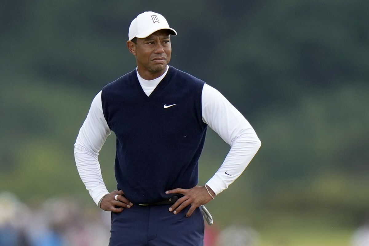 Tiger Woods stands with his hands on his hips at the 11th hole on the Old Course at St. Andrews, Scotland.