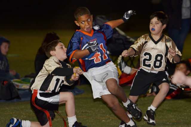 Seven-year-old Malachi Pierce (41 runs through the opposition during the Newport Mesa Friday Night Lights flag football program's Opening Day.