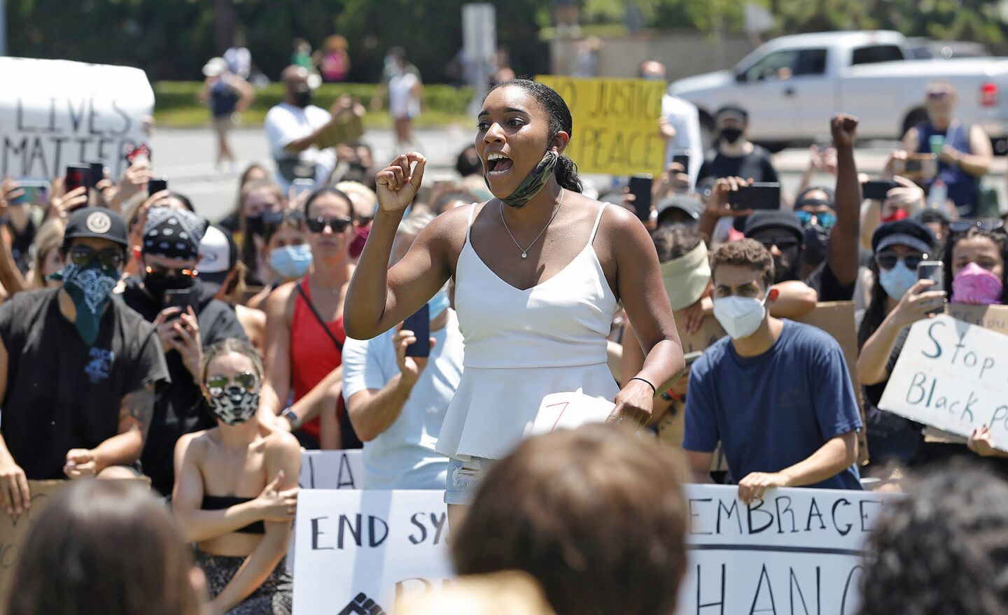 Organizer Alesia Robinson brings together peaceful protesters to thank them for their participation during a Black Lives Matter protest in Newport Beach on Wednesday.