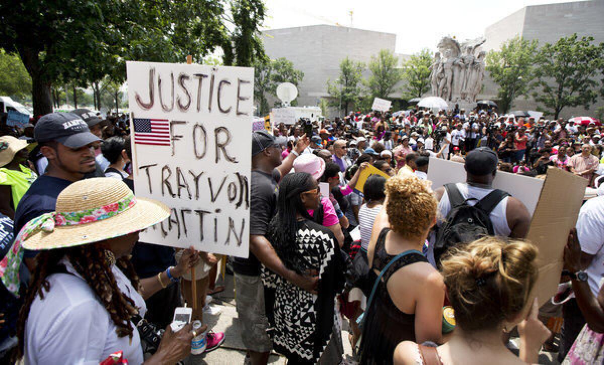 People gather in front of the federal courthouse in Washington on Saturday as they demonstrate in the "Justice for Trayvon -100 City Vigil."