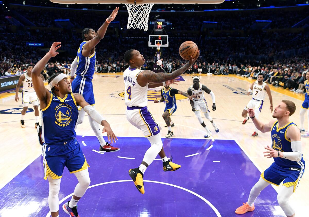 Lakers guard Lonnie Walker IV beats the Warriors defense for a reverse layup.