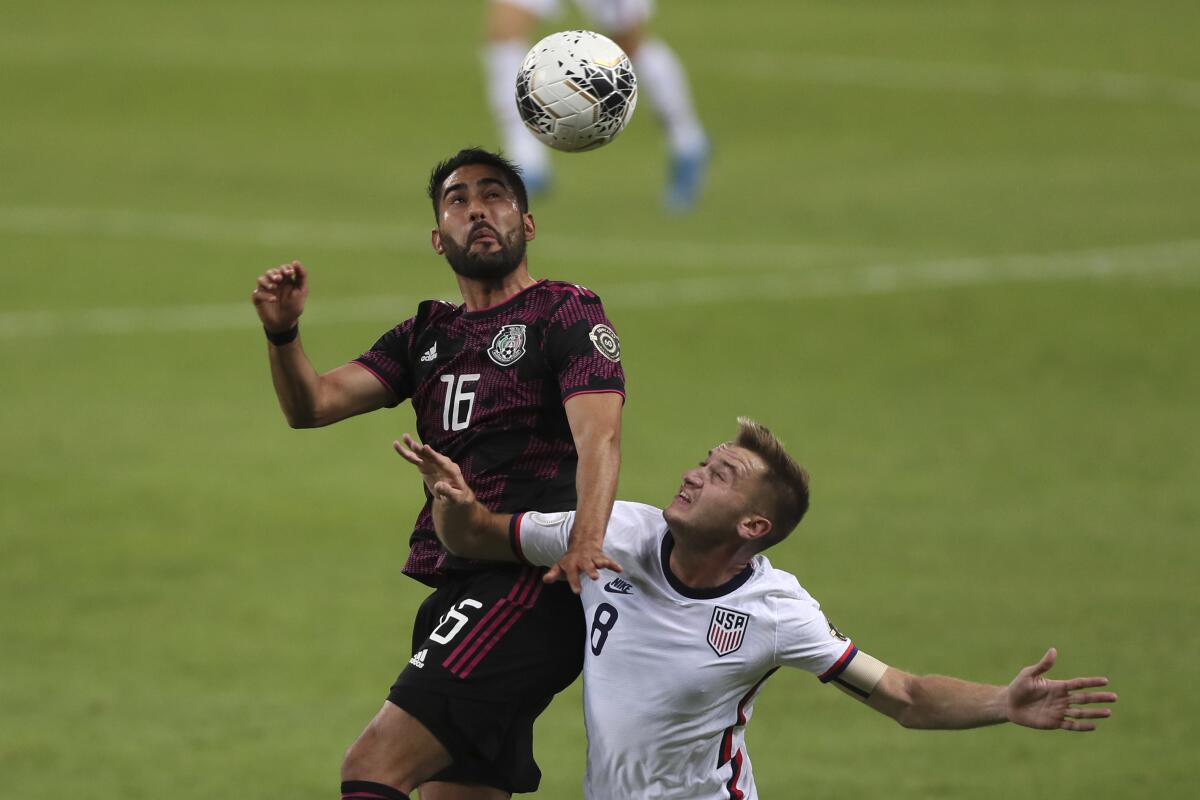 Mexico's Jose Esquivel heads the ball while challenged by the United States' Djordje Mihailovic 