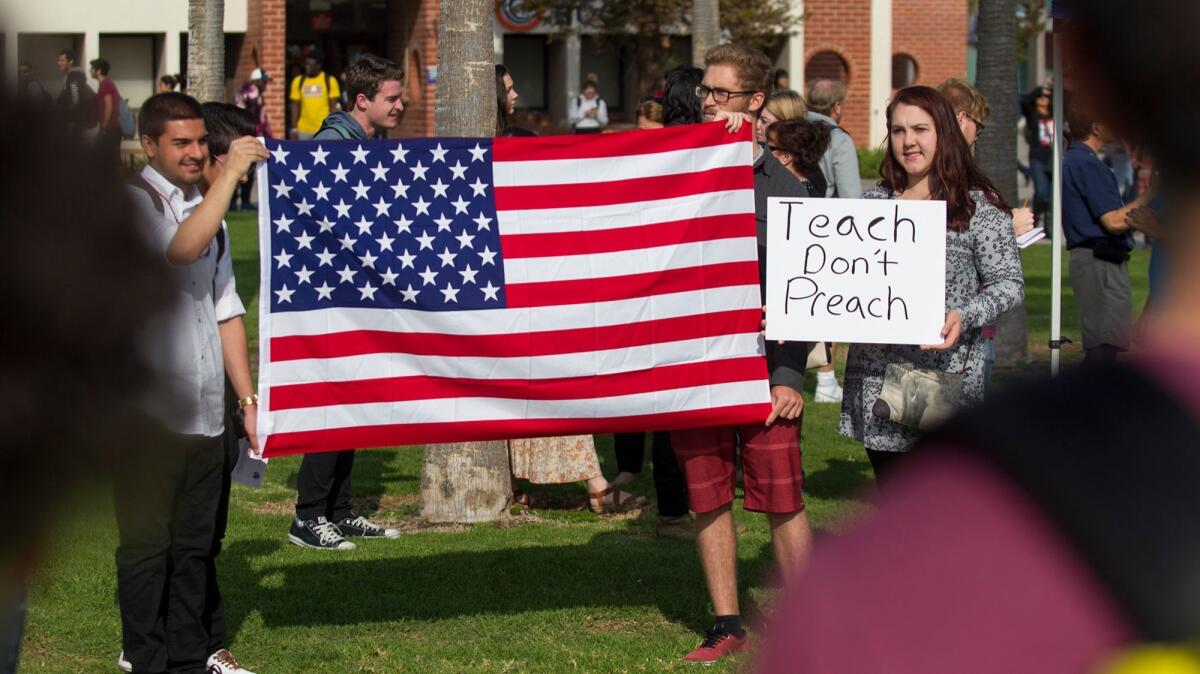 Members of the Republican Club at Orange Coast College hold a counterprotest in December during campus tension over comments by Professor Olga Perez Stable Cox. She was secretly recorded calling President Trump's election victory an "act of terrorism."