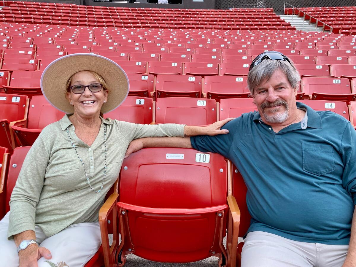 Pageant Legacy Society member Julie Malino and Lyn Waldron flank a seat in Festival of Arts Laguna Beach's Irvine Bowl.