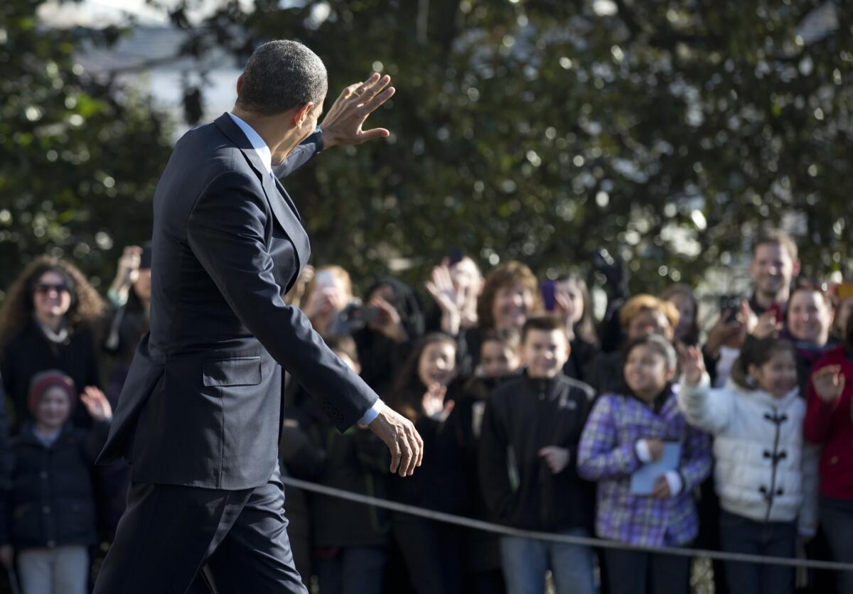 President Obama waves to White House visitors.