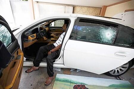 A Libyan sits inside an armoured car at a house belonging to Muammar Gaddafi's son Hannibal in Tripoli.