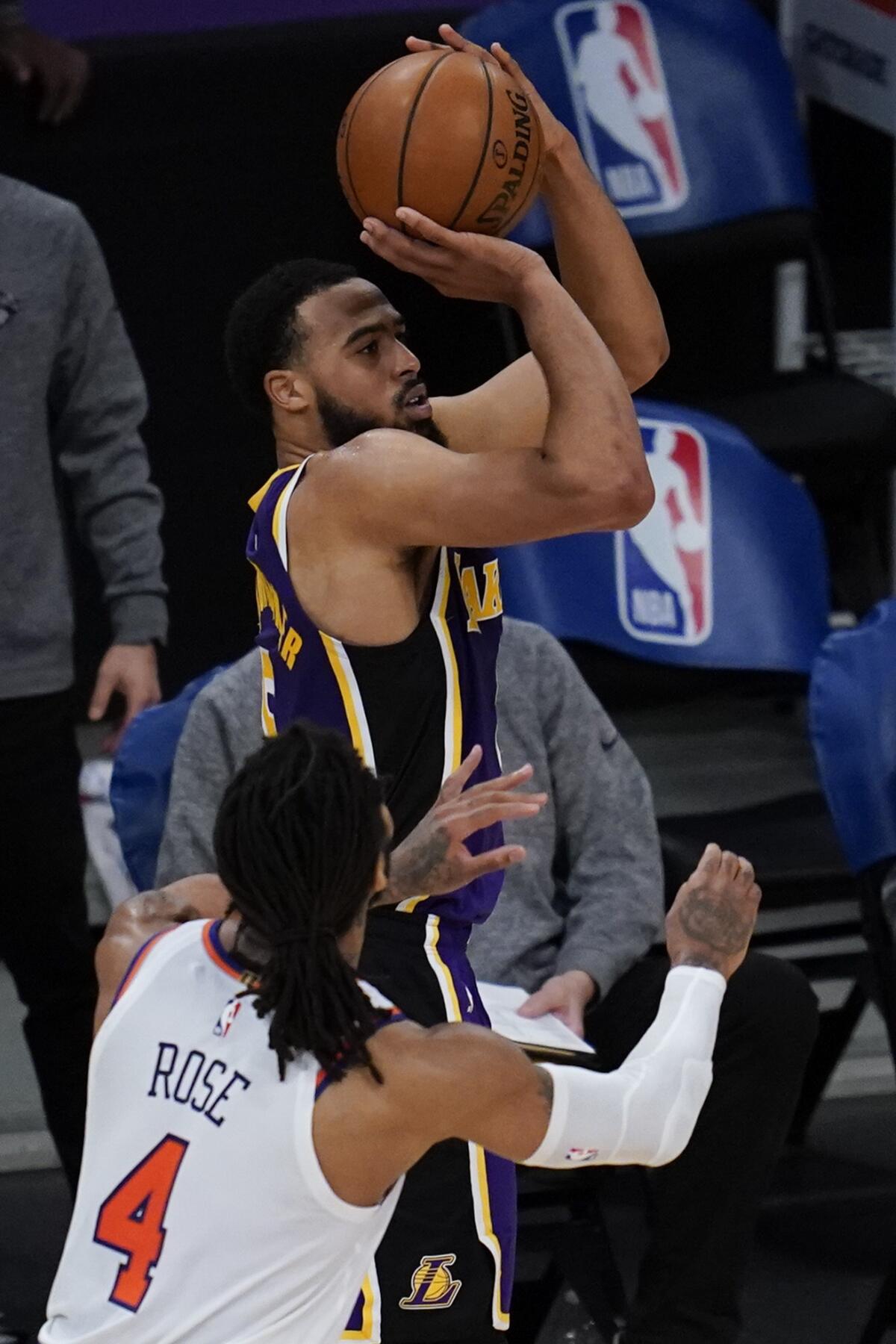 Los Angeles Lakers guard Talen Horton-Tucker shoots against New York Knicks guard Derrick Rose