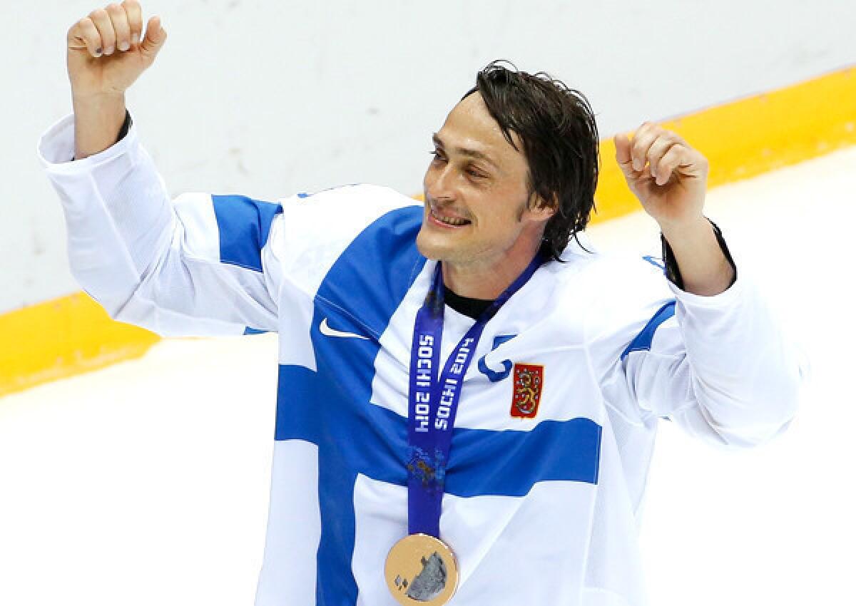 Teemu Selanne takes a victory lap around the ice after helping Finland win the bronze medal at the Sochi Olympics with a 5-0 victory over the United States.