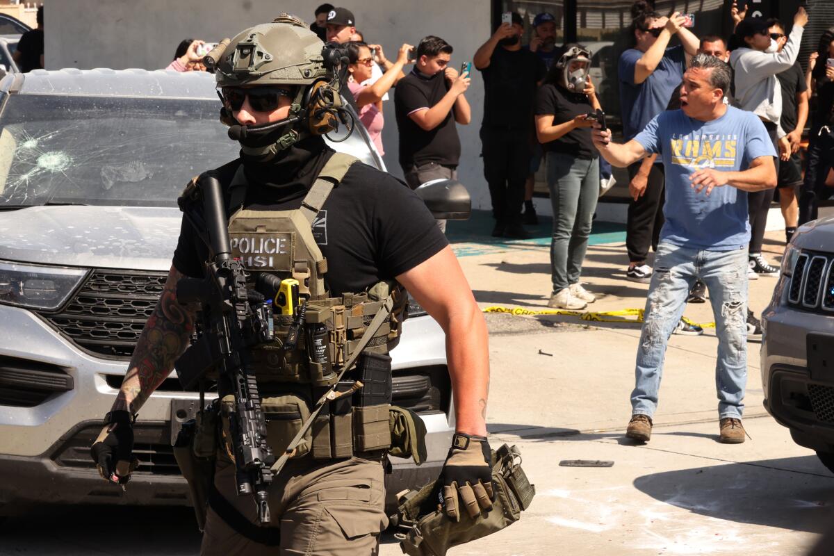Residents confront ICE agents, assisted by Border Patrol agents