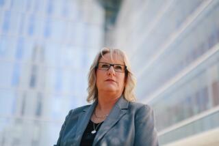 Los Angeles, CA - August 04: LAPD Det. Kristine Klotz, once a member of the vaunted Robbery-Homicide Division, was allegedly retaliated against after accusing a male supervisor or sexual harassment and here poses for a portrait outside LAPD headquarters downtown on Sunday, Aug. 4, 2024 in Los Angeles, CA. Instead of addressing her concerns, Klotz said she faced retaliation in the form of demolition and transfer to the Valley. (Dania Maxwell / Los Angeles Times)