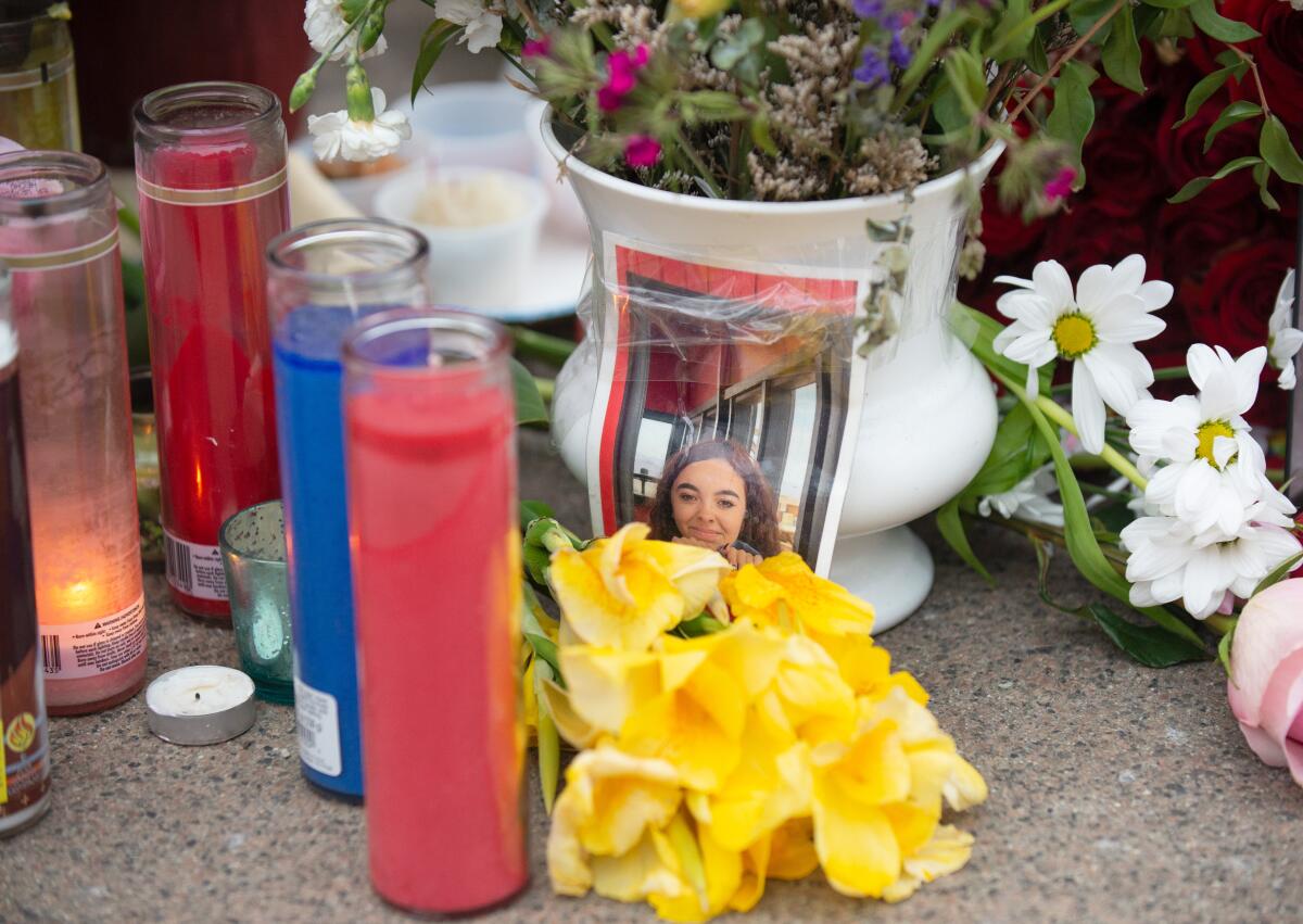 Flowers, candles and cupcakes surround a photo of Rosenda Elizabeth Smiley in Newport Beach.