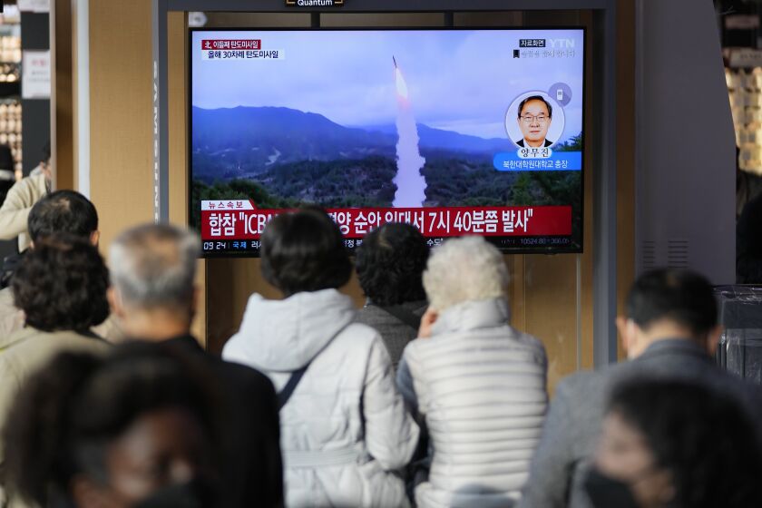 A TV screen showing a news program reporting about North Korea's missile launch with file footage is seen at the Seoul Railway Station in Seoul, South Korea, Thursday, Nov. 3, 2022. North Korea continued its barrage of weapons tests on Thursday, firing at least three missiles including a suspected intercontinental ballistic missile that forced the Japanese government to issue evacuation alerts and temporarily halt trains. (AP Photo/Lee Jin-man)