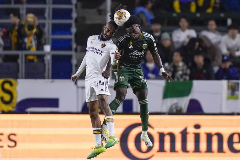 LA Galaxy defender Raheem Edwards, left, and Portland Timbers midfielder Santiago Moreno vie for the ball in the air during the second half of an MLS soccer match, Saturday, Sept. 30, 2023, in Carson, Calif. (AP Photo/Ryan Sun)