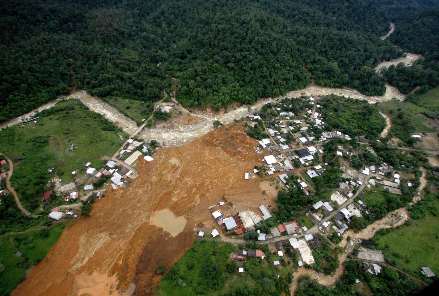 An aerial view of the landslide that buried part of the Mexican village of La Pintada. Remaining structures can be seen on both sides of the spot where the hill gave way, leaving dozens of people missing.