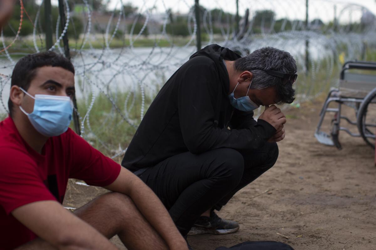 Migrants from Cuba rest after crossing the Rio Grande river in Eagle Pass, Texas.