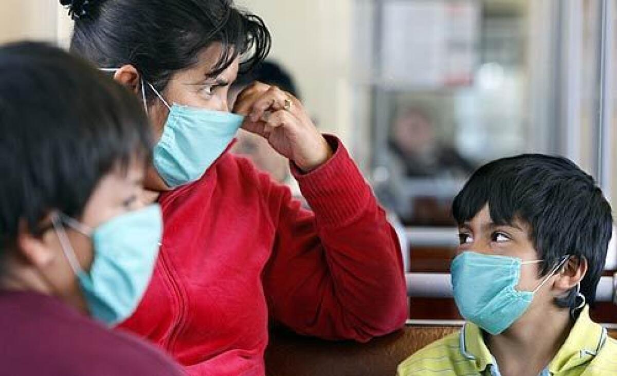 A family wears protective masks as a precaution against the coronavirus.