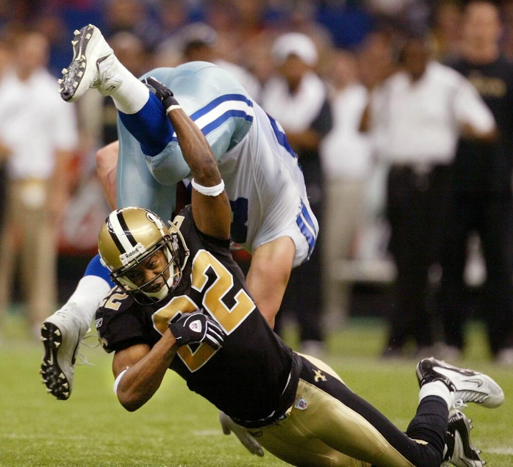 Dallas Cowboys tight end Dan Campbell (86) is flipped by New Orleans Saints cornerback Fred Thomas (22) in fourth quarter action in New Orleans Sunday Dec. 28, 2003. The Saints up-ended the Cowboys, 13-7. (AP Photo/Sue Ogrocki) ORG XMIT: NUA111