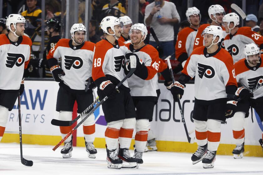 Philadelphia Flyers' Morgan Frost (48) celebrates with teammates after his winning goal in a shootout in overtime during a preseason NHL hockey game against the Boston Bruins, Friday, Sept. 29, 2023, in Boston (AP Photo/Michael Dwyer)