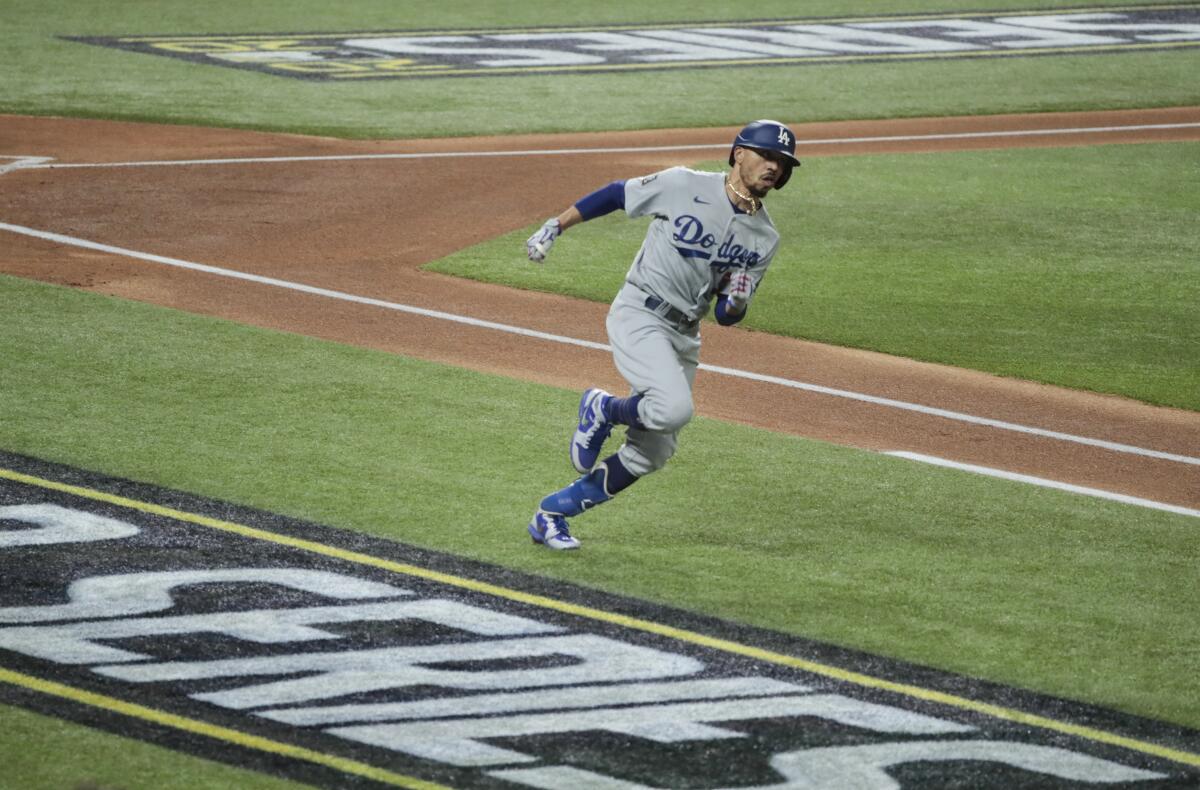 Dodgers right fielder Mookie Betts doubles in the first inning of Game 5.