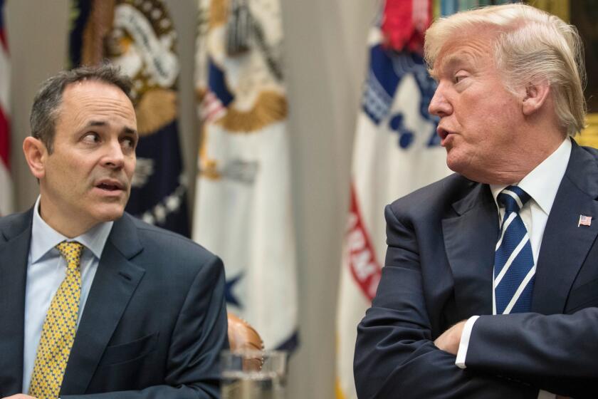 FILE - In this Thursday, Jan. 11, 2018, file photo, President Donald Trump, right, and Kentucky Gov. Matt Bevin, left, talk during a prison reform roundtable in the Roosevelt Room of the Washington. Kentucky has become the first state to win approval from the Trump administration requiring many of its Medicaid recipients to work to receive coverage. The Trump administration gave the go ahead Friday, Jan. 12, 2018. (AP Photo/Carolyn Kaster, File)