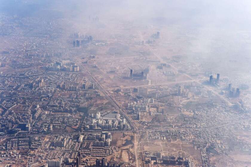 Smog envelops buildings on the outskirts of New Delhi in November.